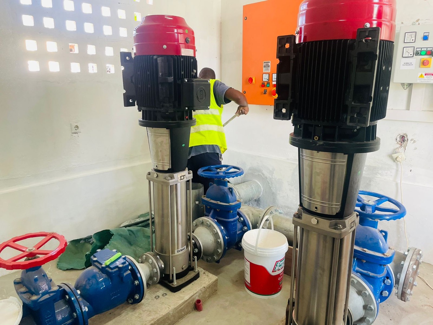 Plano Digital technician working between installed pumps in the Massinga pump room
